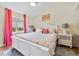 Bedroom with king-size bed and flamingo decor at 26853 Winged Elm Dr, Wesley Chapel, FL 33544