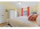 Bedroom with king-size bed and coral accents at 26853 Winged Elm Dr, Wesley Chapel, FL 33544