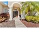 Inviting front entrance with double doors, columns, and lush landscaping at 26853 Winged Elm Dr, Wesley Chapel, FL 33544