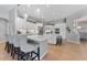 Modern kitchen with white cabinets, large island, and stainless steel appliances at 26853 Winged Elm Dr, Wesley Chapel, FL 33544