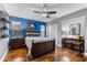 Well-lit bedroom with hardwood floors and a wood bed frame at 3312 Cobbs Ct, Palm Harbor, FL 34684