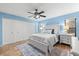 Bedroom with queen bed, light blue walls, and ceiling fan at 3312 Cobbs Ct, Palm Harbor, FL 34684