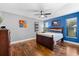 Spacious bedroom with hardwood floors and blue accent wall at 3312 Cobbs Ct, Palm Harbor, FL 34684