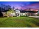 Two-story home with a tile roof, landscaping, and a three-car garage at 3312 Cobbs Ct, Palm Harbor, FL 34684