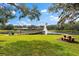 Scenic lakefront view with gazebo and picnic table at 3312 Cobbs Ct, Palm Harbor, FL 34684