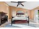 Main bedroom with high ceiling, tiled floors, and large bed at 3312 Cobbs Ct, Palm Harbor, FL 34684