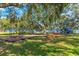 playground with swings and play structures at 3312 Cobbs Ct, Palm Harbor, FL 34684