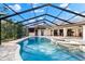 Inviting pool area with spa and screened enclosure at 3312 Cobbs Ct, Palm Harbor, FL 34684