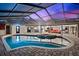 Inviting screened pool area with a spa at dusk at 3312 Cobbs Ct, Palm Harbor, FL 34684