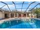 Beautiful screened pool and spa with a covered patio at 3312 Cobbs Ct, Palm Harbor, FL 34684