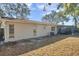 Rear view of a single-story house with a screened patio at 3917 Briarlake Dr, Valrico, FL 33596