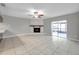 Bright living room with a fireplace and sliding glass doors leading to the patio at 3917 Briarlake Dr, Valrico, FL 33596