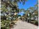 Scenic paved bike path lined with lush trees at 400 Glennes Ln # 108, Dunedin, FL 34698