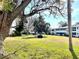 Community courtyard with grassy lawn and trees at 400 Glennes Ln # 108, Dunedin, FL 34698