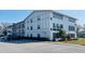 Exterior view of a two-story building with parking at 400 Glennes Ln # 108, Dunedin, FL 34698