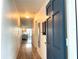 Hallway with light wood floors leading to living area at 400 Glennes Ln # 108, Dunedin, FL 34698