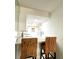 Kitchen breakfast bar with two woven chairs at 400 Glennes Ln # 108, Dunedin, FL 34698