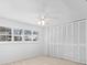 Bedroom with neutral carpet, ceiling fan, and large closet at 4001 Harbor Hills Dr, Largo, FL 33770