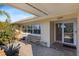 Charming front entrance features an awning, stylish seating, and beautiful landscaping leading to the front door at 4001 Harbor Hills Dr, Largo, FL 33770