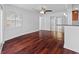 Sunlit living room with hardwood floors, ceiling fan, and views into kitchen at 4001 Harbor Hills Dr, Largo, FL 33770