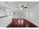 Open living room with dark hardwood flooring and lots of natural light from windows with plantation shutters at 4001 Harbor Hills Dr, Largo, FL 33770