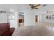 Expansive, bright living room with access to the kitchen, tile and hardwood floors, and several ceiling fans at 4001 Harbor Hills Dr, Largo, FL 33770