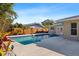 Private fenced pool area boasts a tranquil escape in a tropical backyard setting at 4001 Harbor Hills Dr, Largo, FL 33770