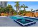 Backyard pool with lush tropical landscaping is the perfect place to cool off at 4001 Harbor Hills Dr, Largo, FL 33770