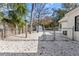 Fenced backyard with gravel ground cover and storage shed at 4020 S West Shore Blvd, Tampa, FL 33611