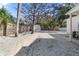 Large backyard with gravel ground cover and mature trees at 4020 S West Shore Blvd, Tampa, FL 33611