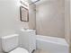 Clean bathroom, beige tile, white vanity, and tub at 4020 S West Shore Blvd, Tampa, FL 33611