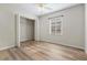 Bedroom with wood-look floors, closet, and window at 4020 S West Shore Blvd, Tampa, FL 33611