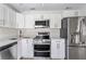 Modern kitchen with stainless steel appliances and white cabinets at 4020 S West Shore Blvd, Tampa, FL 33611