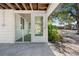 Bright screened porch with a green carpet floor and white door at 4020 S West Shore Blvd, Tampa, FL 33611