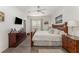 Spacious main bedroom with king-size bed, wood dresser, and ceiling fan at 4079 Overture Cir # 346, Bradenton, FL 34209