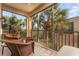 Relaxing screened balcony overlooking lush tropical landscape with wicker furniture at 4079 Overture Cir # 346, Bradenton, FL 34209