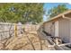 Backyard with wooden fence, landscaping and exterior door at 5157 School Rd, New Port Richey, FL 34653