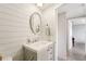 Guest bathroom with a farmhouse-style vanity and shiplap walls at 5157 School Rd, New Port Richey, FL 34653