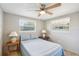 Guest bedroom with a full-size bed, nightstands, and ceiling fan at 5157 School Rd, New Port Richey, FL 34653