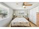 Bedroom with double bed, ceiling fan, and ample sunlight at 5157 School Rd, New Port Richey, FL 34653