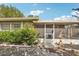 House exterior showcasing a screened porch and landscaping at 5157 School Rd, New Port Richey, FL 34653