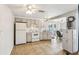 Kitchen with white appliances, light beige cabinets, and tile floors at 5157 School Rd, New Port Richey, FL 34653