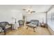 Living room with wicker furniture, tile floors, and ceiling fan at 5157 School Rd, New Port Richey, FL 34653