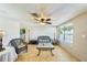 Living room with wicker furniture, tile floors, and ceiling fan at 5157 School Rd, New Port Richey, FL 34653