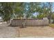 House exterior showing a side yard with gravel and wooden fence at 5157 School Rd, New Port Richey, FL 34653