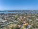 Wide aerial view of the property nestled within a verdant, tree-filled neighborhood with bay views at 540 Villagrande S Ave, St Petersburg, FL 33707