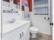 Bathroom featuring a sink, toilet, and white wainscoting at 540 Villagrande S Ave, St Petersburg, FL 33707