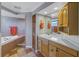 A well-lit bathroom featuring a bathtub, sink, and tile flooring at 540 Villagrande S Ave, St Petersburg, FL 33707