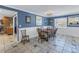 Dining room featuring blue walls, white wainscotting, and natural light from the large window at 540 Villagrande S Ave, St Petersburg, FL 33707