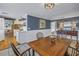 Open dining room with hardwood floors leading to a modern, white kitchen at 540 Villagrande S Ave, St Petersburg, FL 33707